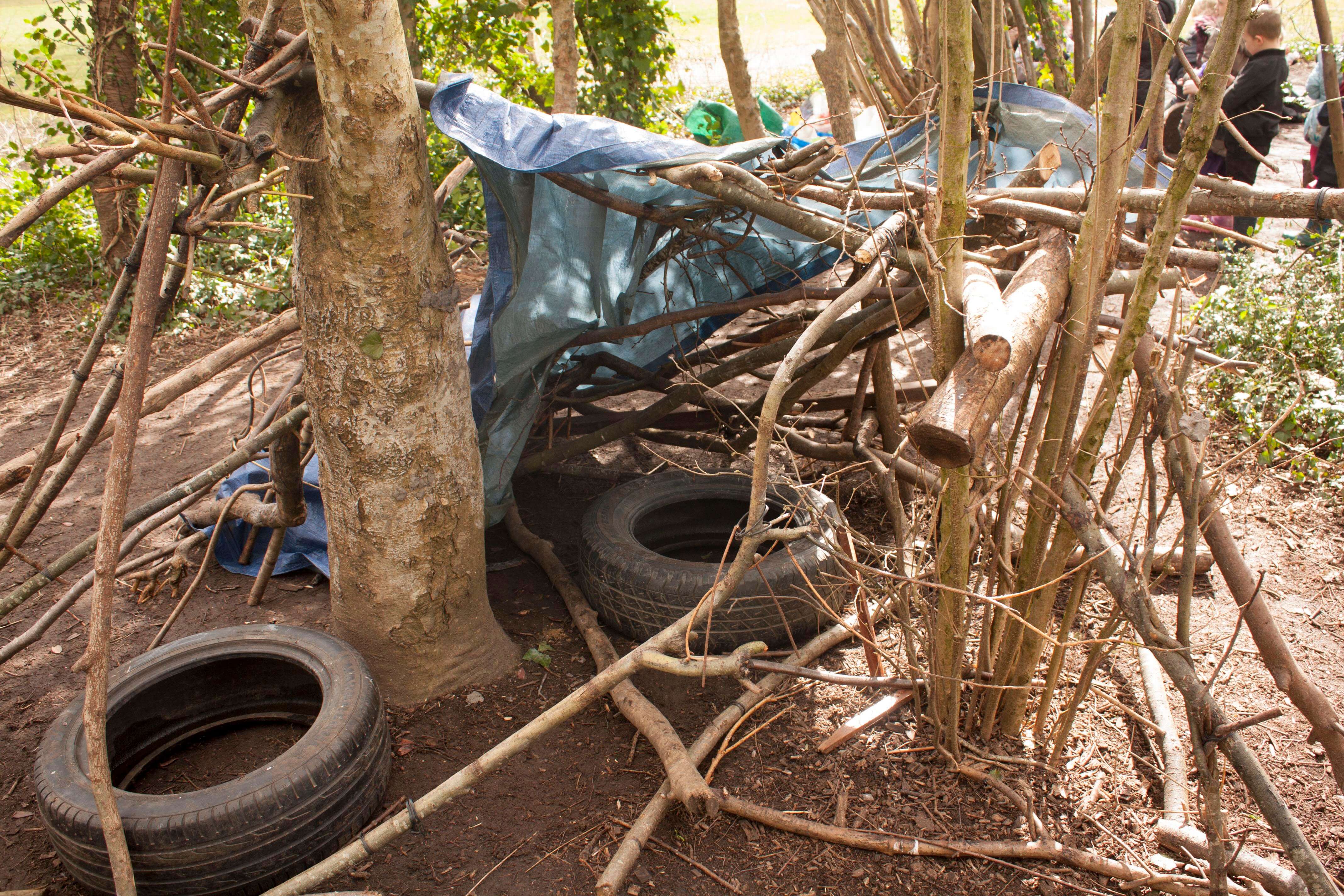 A den made by students in the woods